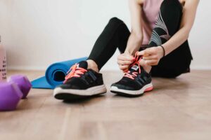 Coronavirus, a woman tying her shoes