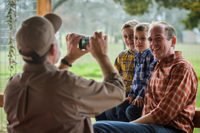 Age affects self-esteem. image of an old man taking a photo of three person