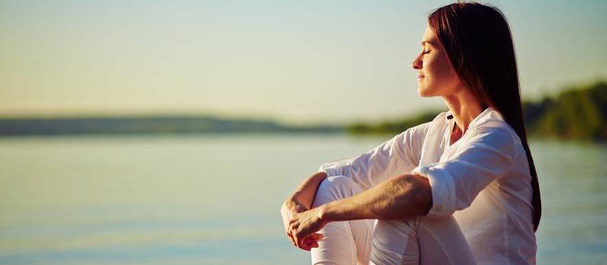 HUmility, image of a woman sitting and seeing the ocean