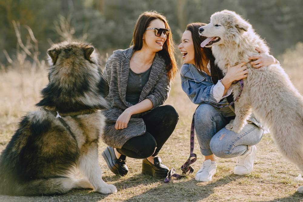 happiness chemical. image of two girls with their pets laughing