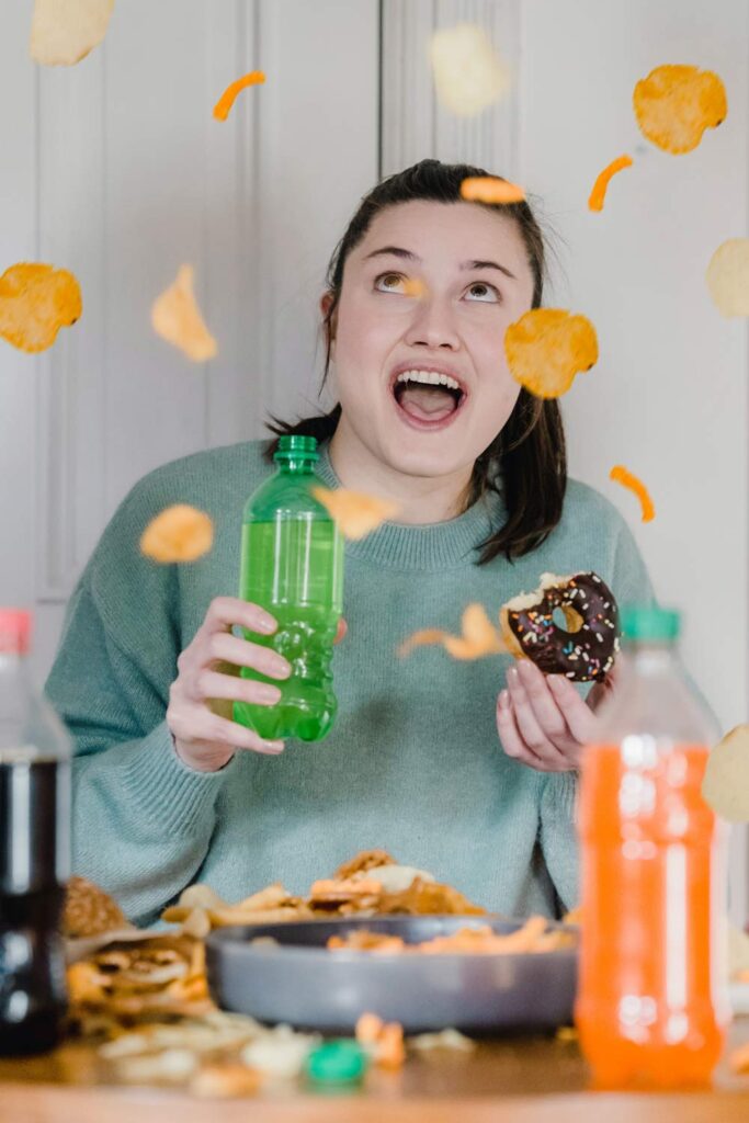 happiness chemical. woman eating, chips, donut and soda
