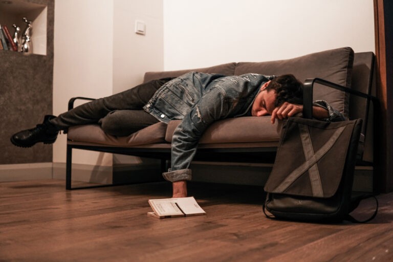 collapse sleeping, an image of a man sleeping on a couch