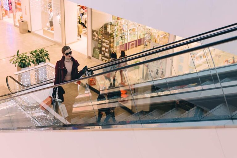 Retail Therapy, an image of woman in escalator with shopping bags