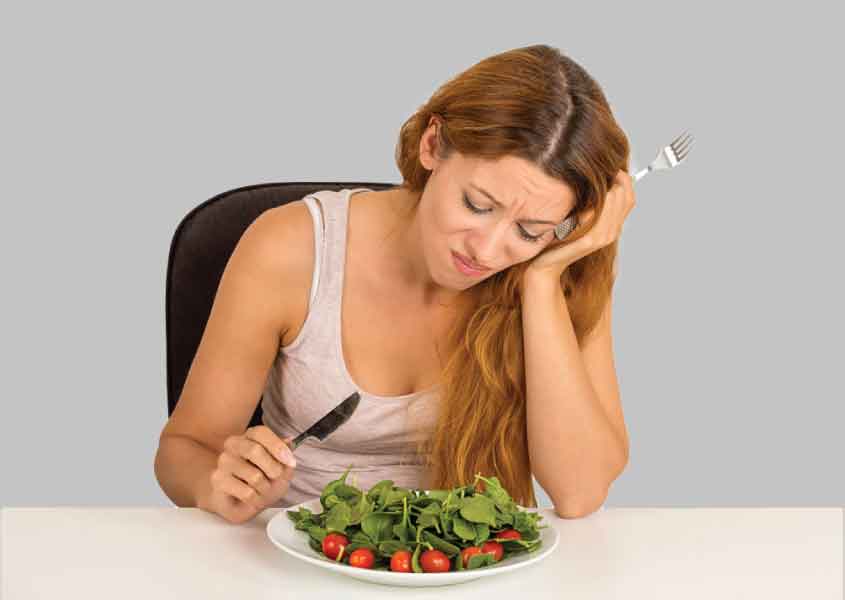 Vegetarian diet, a woman sad face while eating vegetable