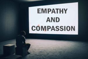 Man Sitting in Front of Turned-on Screen with wording of empathy and compassion