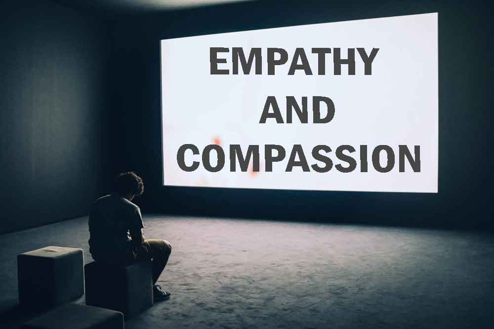 empathy, compassion, Man Sitting in Front of Turned-on Screen with wording of empathy and compassion
