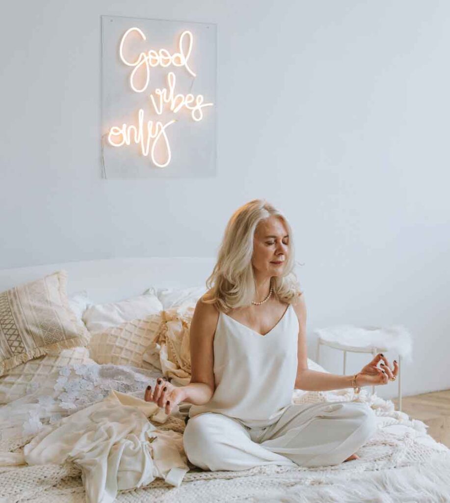 Happiness Baseline, a woman sitting on her bed